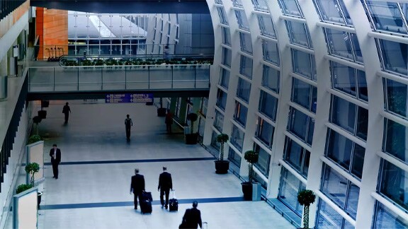 Interior motion picture of people walking in the Airport terminal