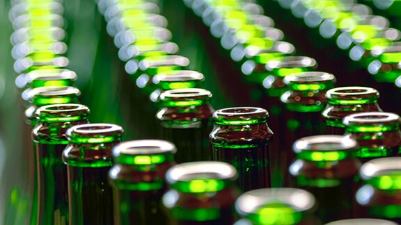 Green Glass bottles on the production line